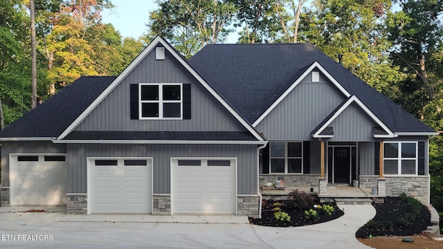 view of front of home with stone siding and roof with shingles
