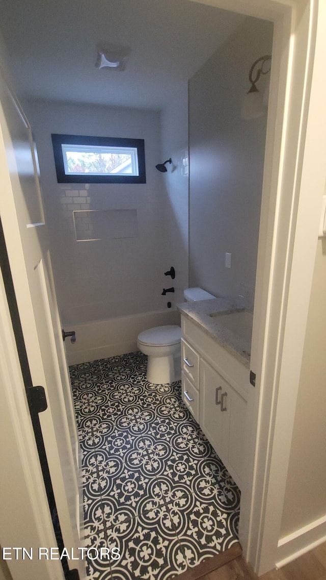 full bathroom featuring bathing tub / shower combination, tile patterned floors, vanity, and toilet