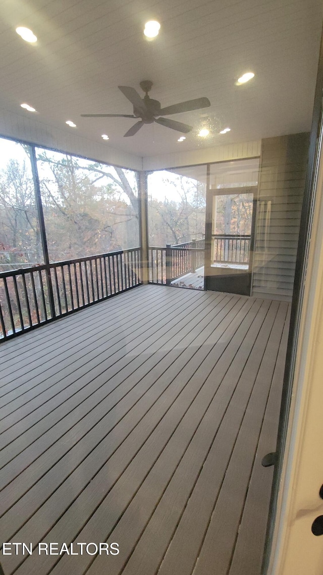 wooden terrace featuring ceiling fan