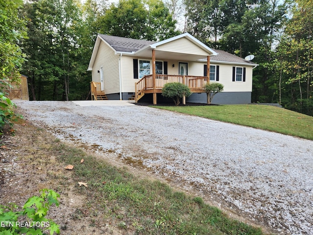 ranch-style house with a porch and a front yard