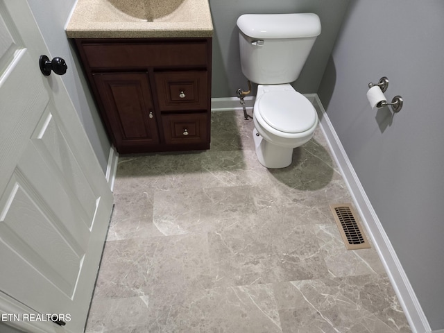 bathroom featuring vanity and toilet