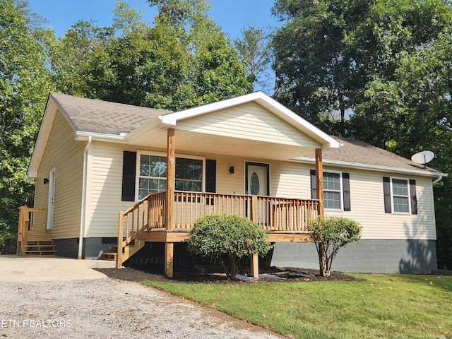 ranch-style home with covered porch and a front lawn