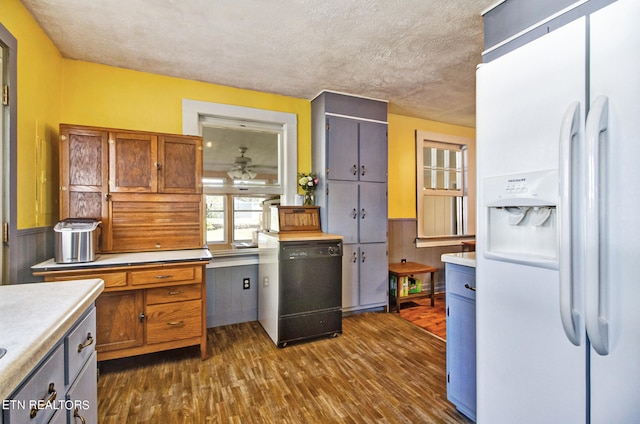 kitchen featuring a textured ceiling, dark hardwood / wood-style flooring, dishwasher, white fridge with ice dispenser, and ceiling fan