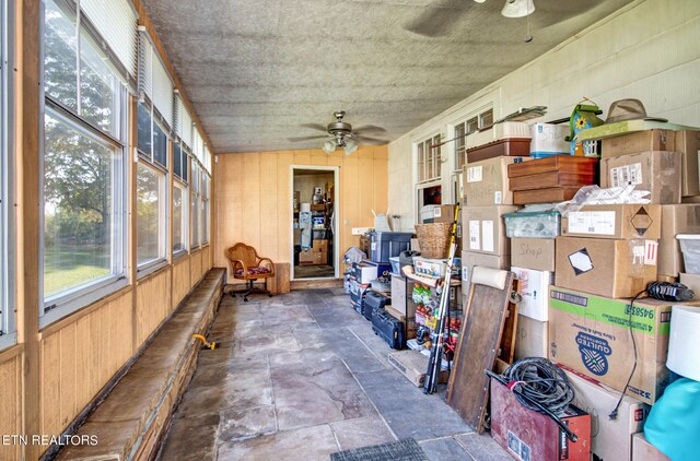 sunroom featuring ceiling fan