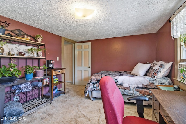 carpeted bedroom with a textured ceiling