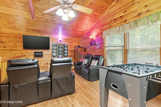 interior space featuring light hardwood / wood-style flooring, wood ceiling, wood walls, ceiling fan, and vaulted ceiling with beams