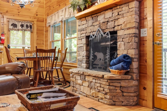 living room featuring wood walls, hardwood / wood-style floors, and a fireplace