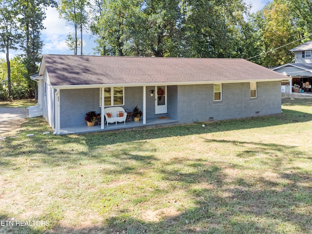 single story home featuring a porch and a front lawn