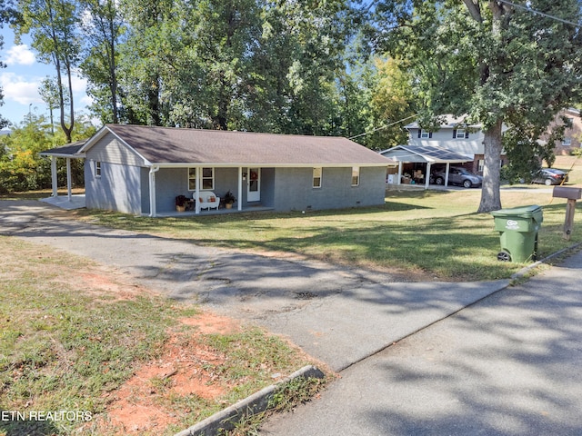 ranch-style home featuring a front lawn and covered porch