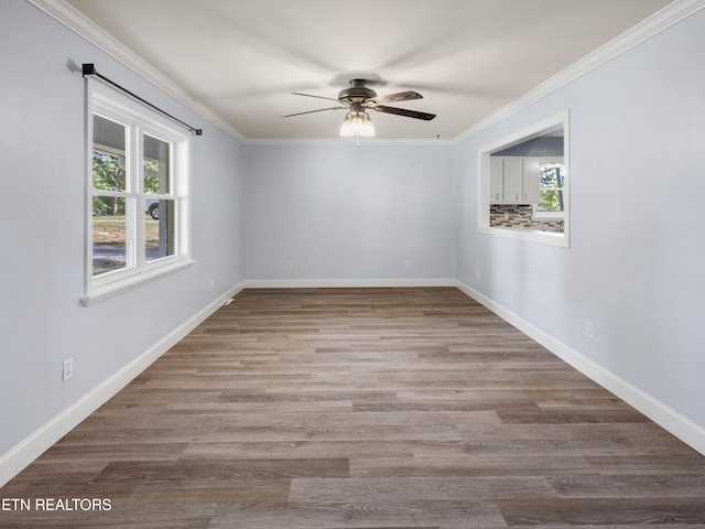 unfurnished room with ceiling fan, hardwood / wood-style floors, and ornamental molding