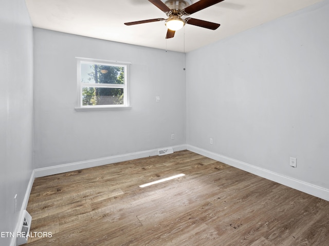 empty room featuring wood-type flooring and ceiling fan