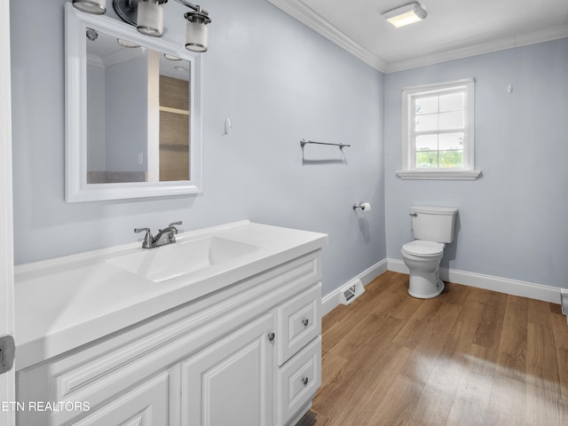 bathroom featuring hardwood / wood-style floors, vanity, toilet, and ornamental molding