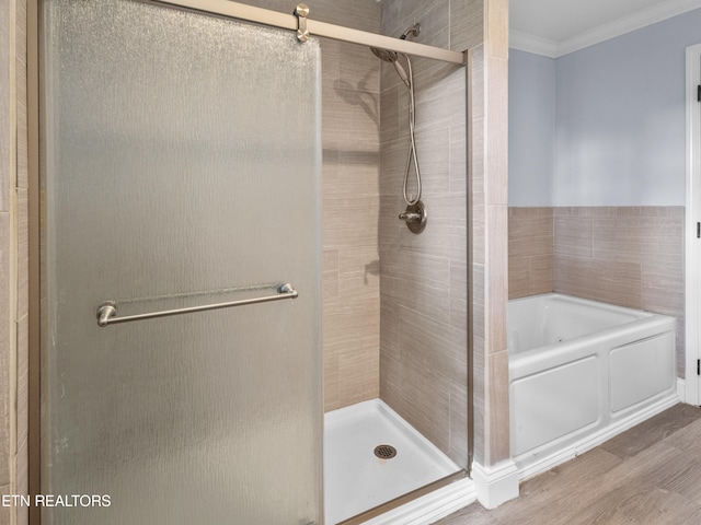 bathroom with crown molding, shower with separate bathtub, and hardwood / wood-style flooring