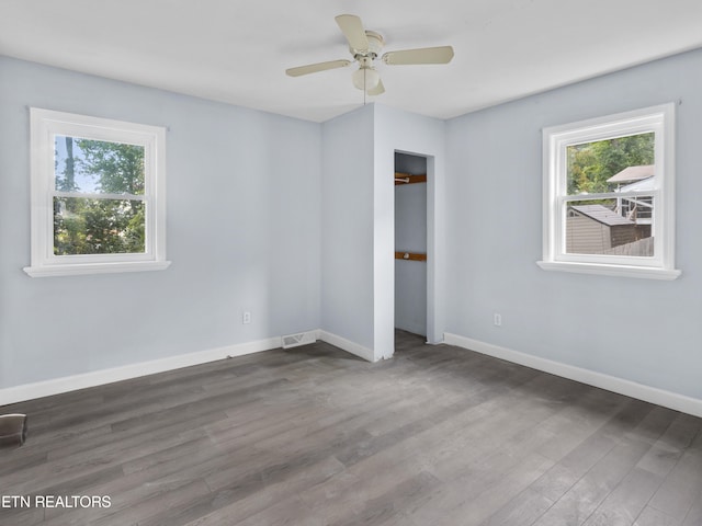 unfurnished bedroom with ceiling fan and wood-type flooring