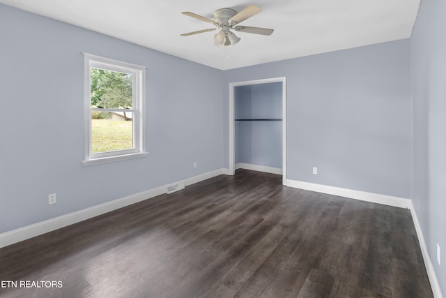 unfurnished bedroom featuring dark hardwood / wood-style flooring and ceiling fan