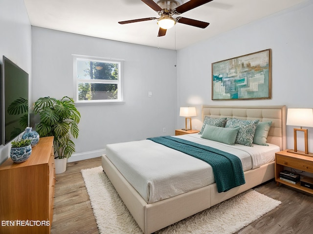 bedroom featuring ceiling fan and wood-type flooring