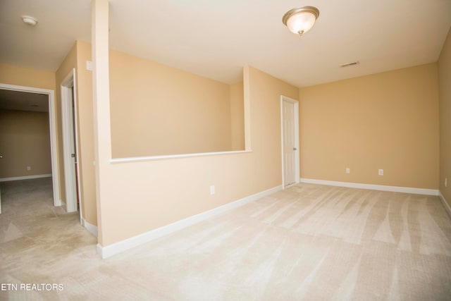 spare room with light colored carpet