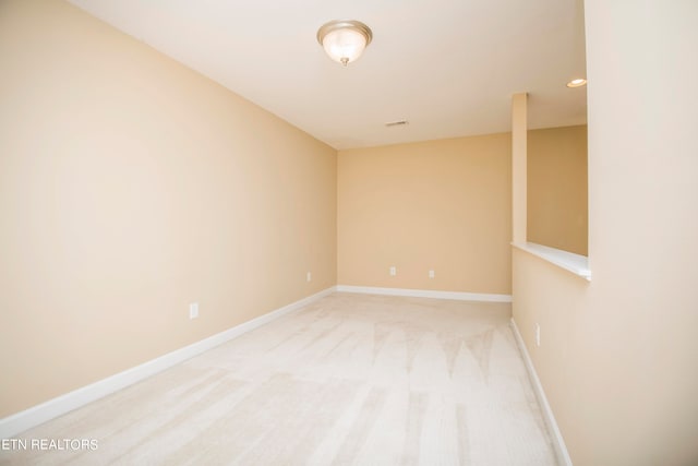 unfurnished room with light colored carpet