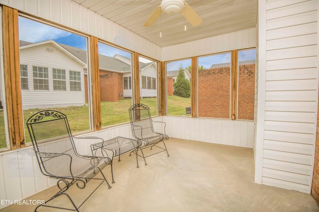 sunroom featuring ceiling fan and a healthy amount of sunlight