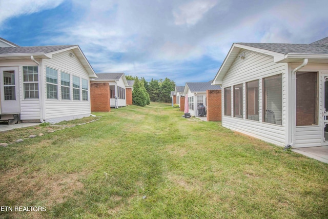 view of yard featuring a sunroom