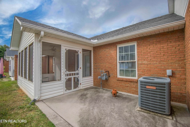 exterior space with a sunroom and central AC