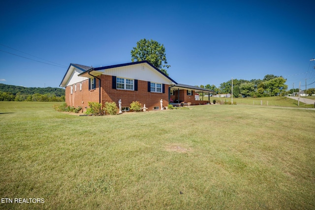 exterior space featuring a yard and brick siding