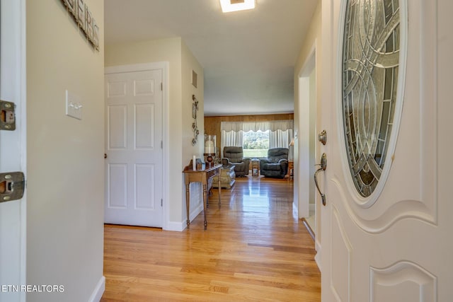 entrance foyer featuring light wood finished floors, visible vents, and baseboards