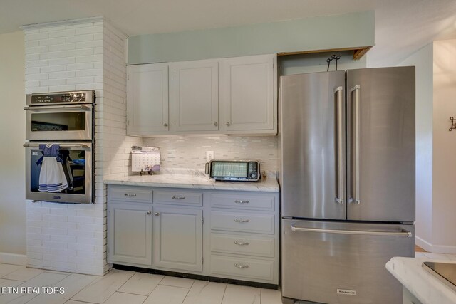 kitchen featuring appliances with stainless steel finishes and decorative backsplash