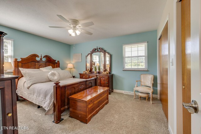 carpeted bedroom with ceiling fan