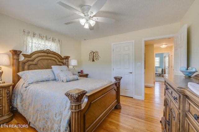 bedroom featuring ceiling fan, light wood-style flooring, and baseboards