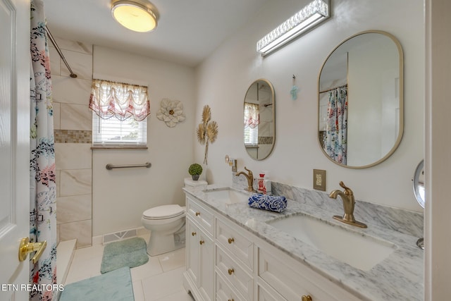 bathroom with a shower with shower curtain, tile patterned flooring, vanity, and toilet