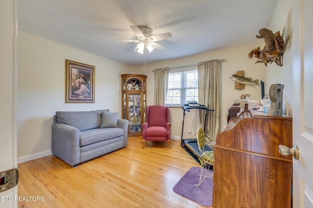 office space featuring wood finished floors, a ceiling fan, and baseboards