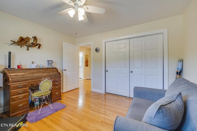 home office featuring baseboards, ceiling fan, and light wood-style floors