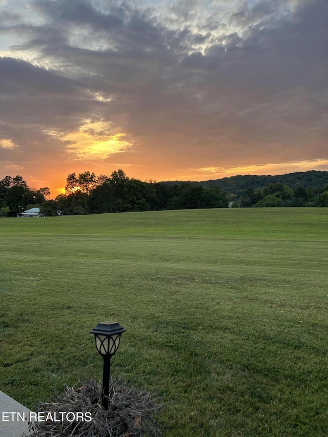 view of home's community featuring a rural view and a lawn