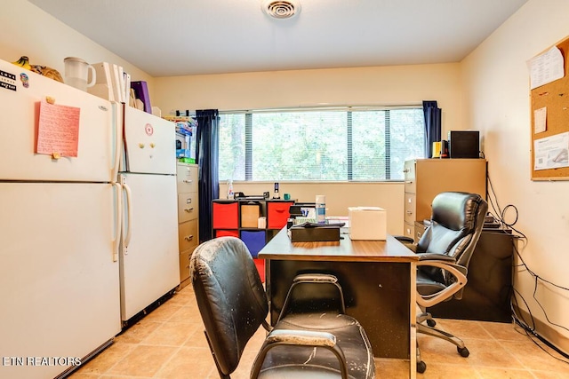 office featuring light tile patterned flooring, a healthy amount of sunlight, and visible vents