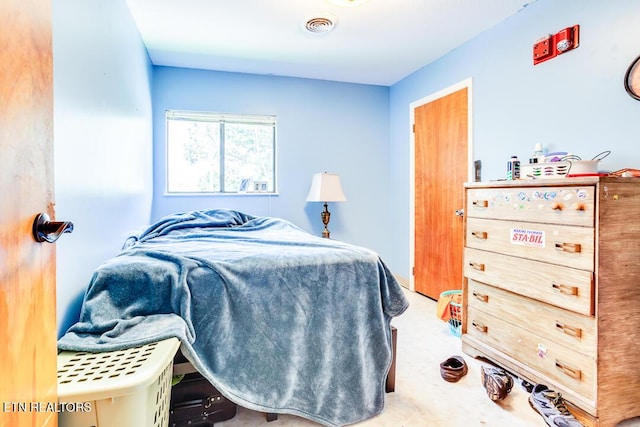 carpeted bedroom featuring visible vents