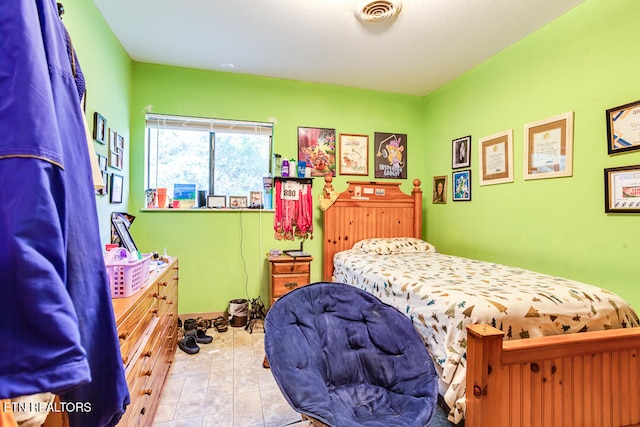 bedroom featuring light tile patterned floors