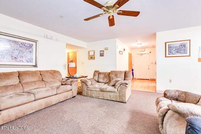 living room featuring hardwood / wood-style floors and ceiling fan