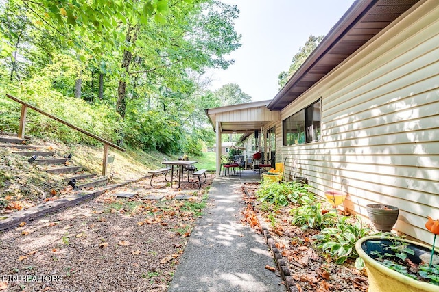 view of yard featuring outdoor dining space and a patio
