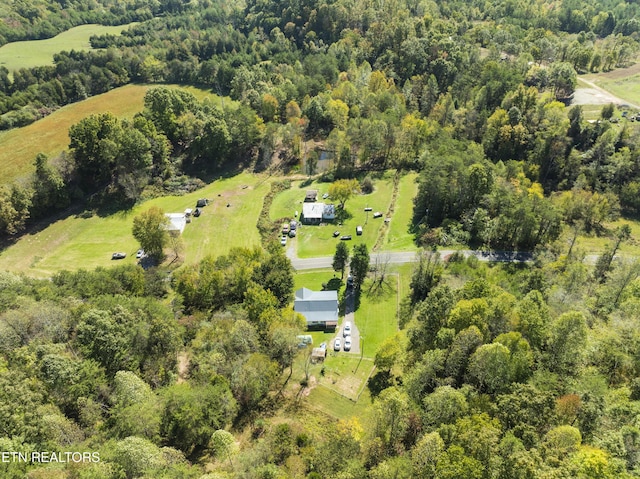 birds eye view of property featuring a wooded view