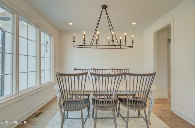 dining room featuring light hardwood / wood-style flooring and a chandelier