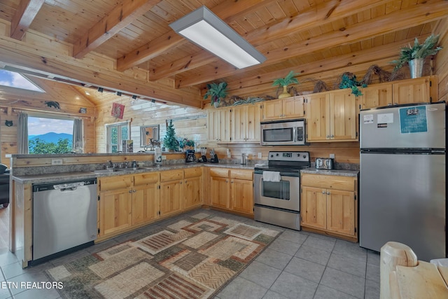 kitchen with wood walls, light tile patterned floors, appliances with stainless steel finishes, beamed ceiling, and wood ceiling