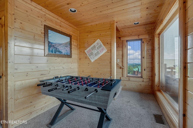 playroom featuring light carpet, wood walls, and wood ceiling