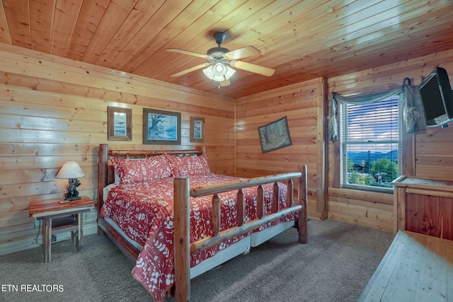 bedroom featuring carpet, ceiling fan, wood walls, and wood ceiling