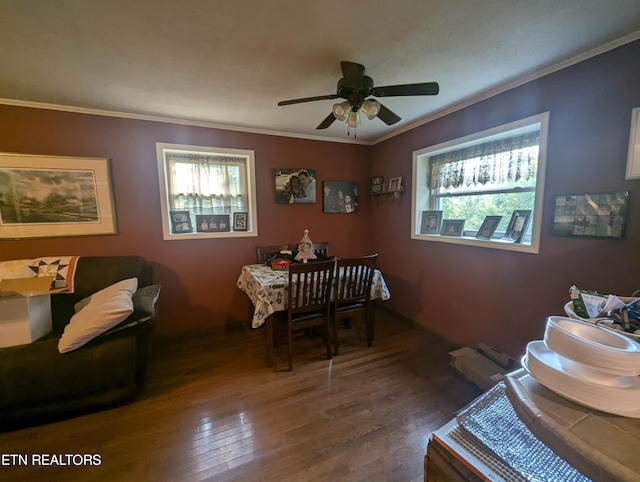 dining space featuring dark hardwood / wood-style flooring, ceiling fan, and crown molding