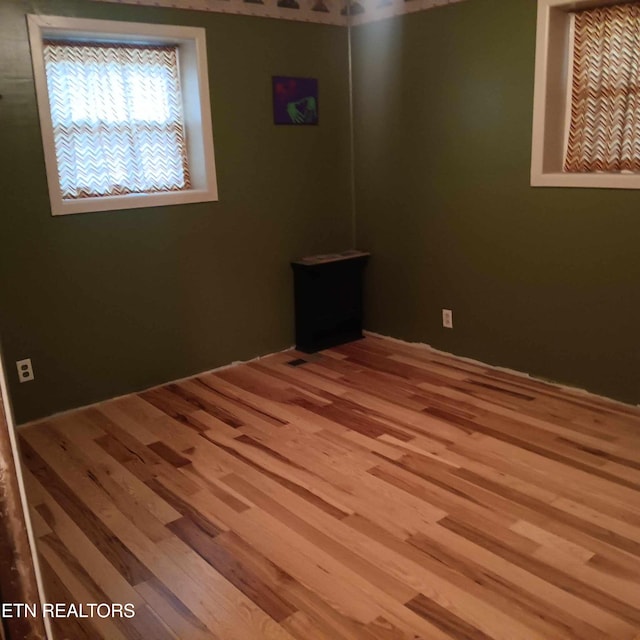 spare room featuring light hardwood / wood-style floors