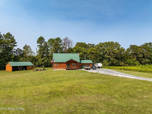 log-style house featuring a storage shed and a front yard