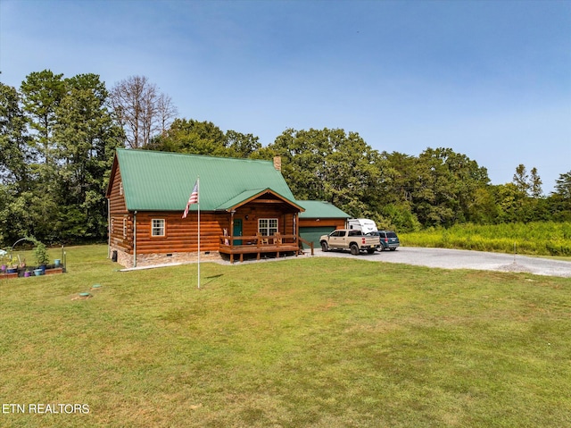 log-style house with a wooden deck and a front yard