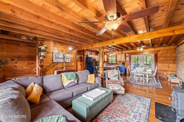 living room with wood ceiling, ceiling fan, wooden walls, and hardwood / wood-style flooring