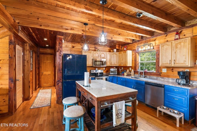 kitchen featuring a kitchen island, stainless steel appliances, sink, and light hardwood / wood-style floors